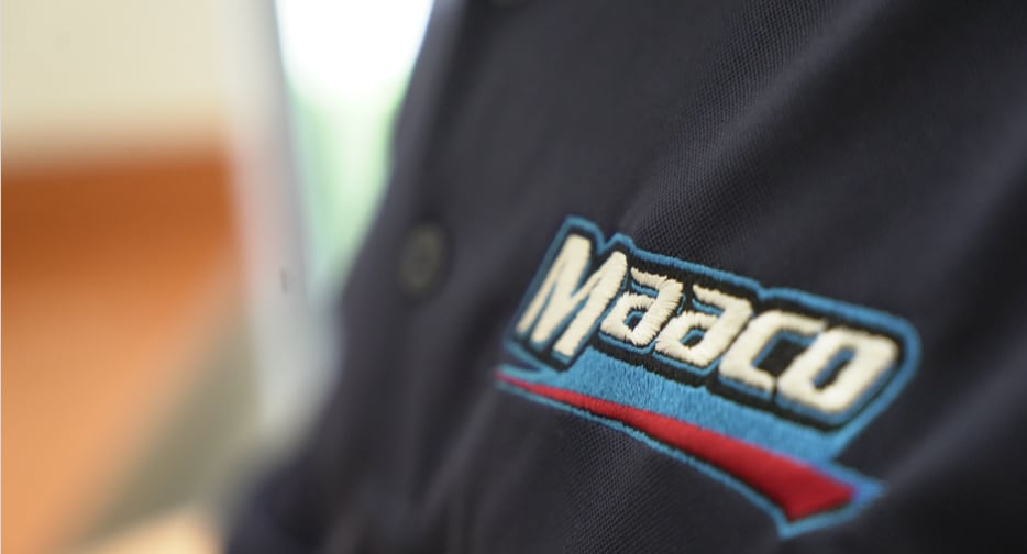 Closeup of logo on Maaco uniform